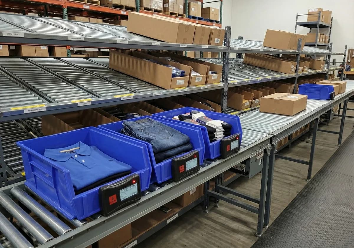 Hero Bot Pick-to-Light devices mounted on blue warehouse bins